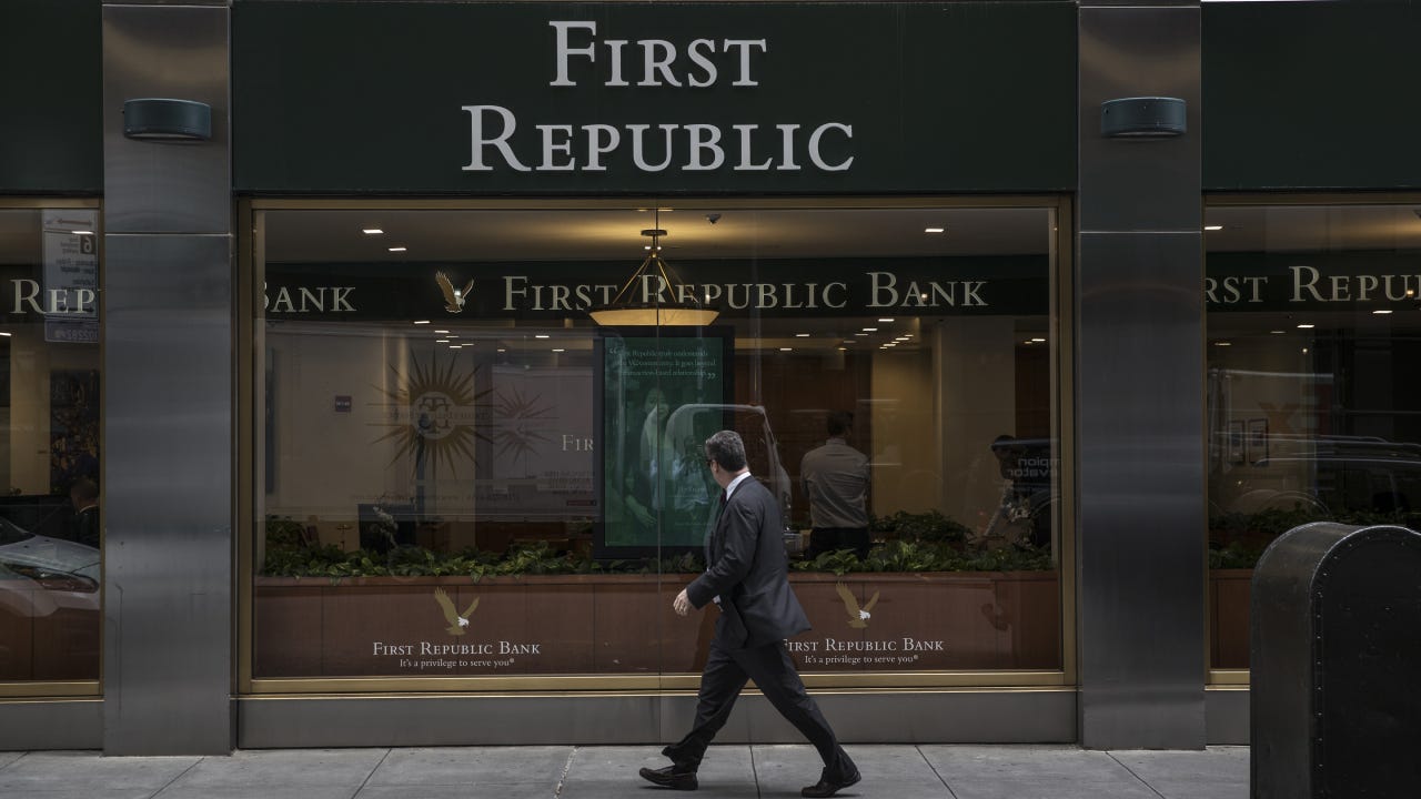A pedestrian passes in front of a First Republic Bank