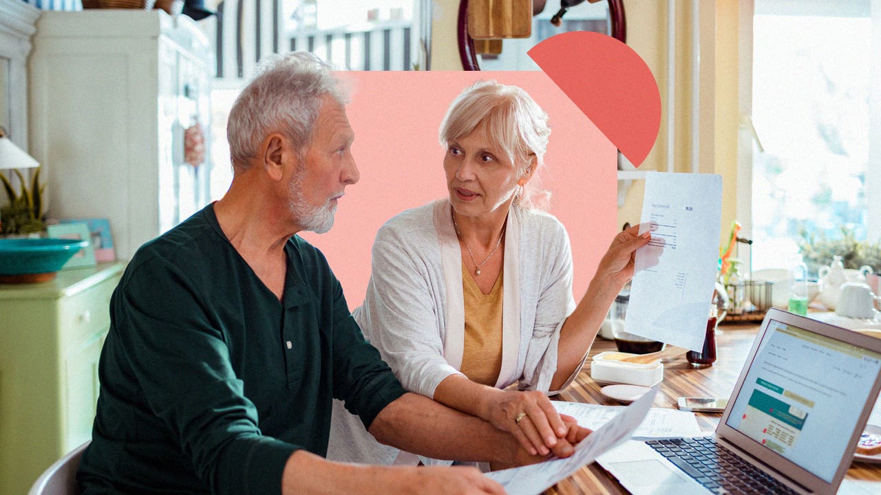 Older couple talking to each other about financial documents