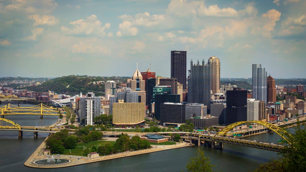 Pittsburgh as seen from Mount Washington. The skyline is crisp and colorful, accented by a nice blue sky with some scattered clouds.