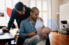A gay couple taking care of a baby.