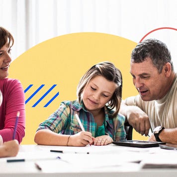A four person family with children gathered around coloring books