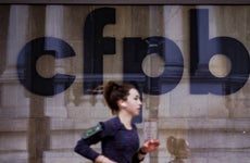 A jogger runs past CFPB building