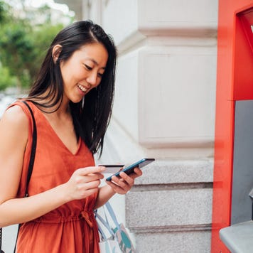 Young woman using an ATM