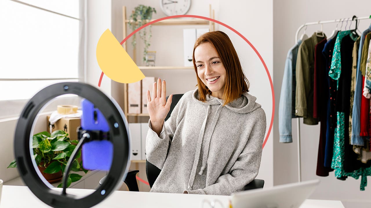 Young woman filming with a ring light in her room