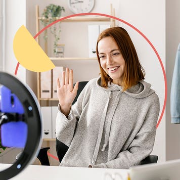 Young woman filming with a ring light in her room