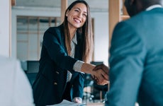 Young professional woman shaking hands