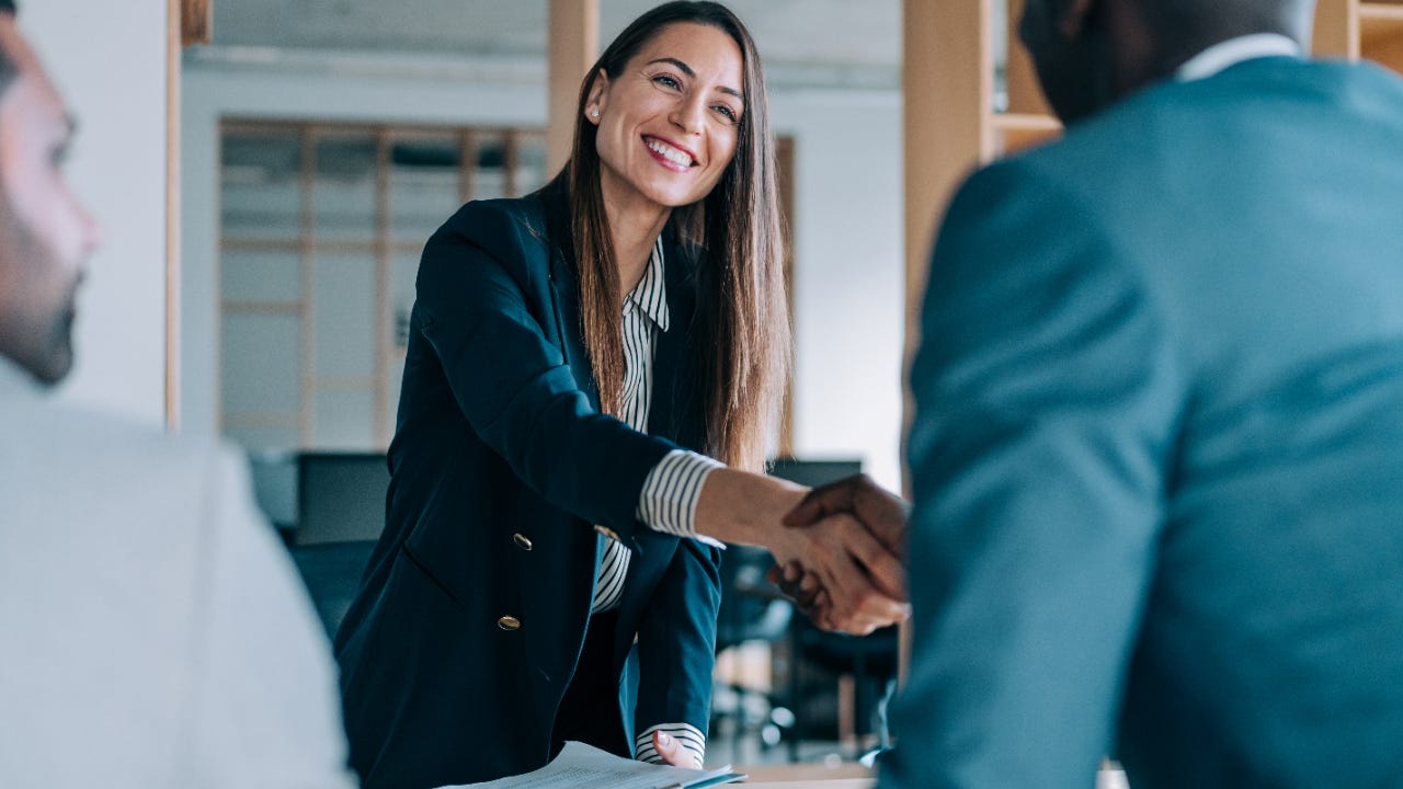 Young professional woman shaking hands