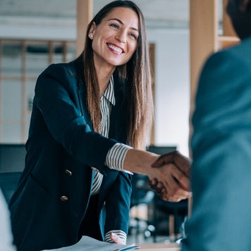 Young professional woman shaking hands