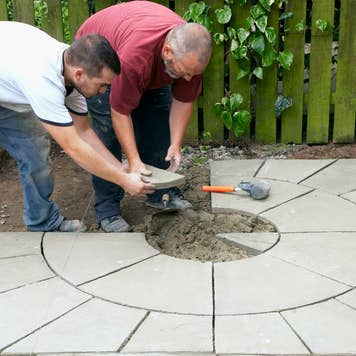 Two men laying down patio