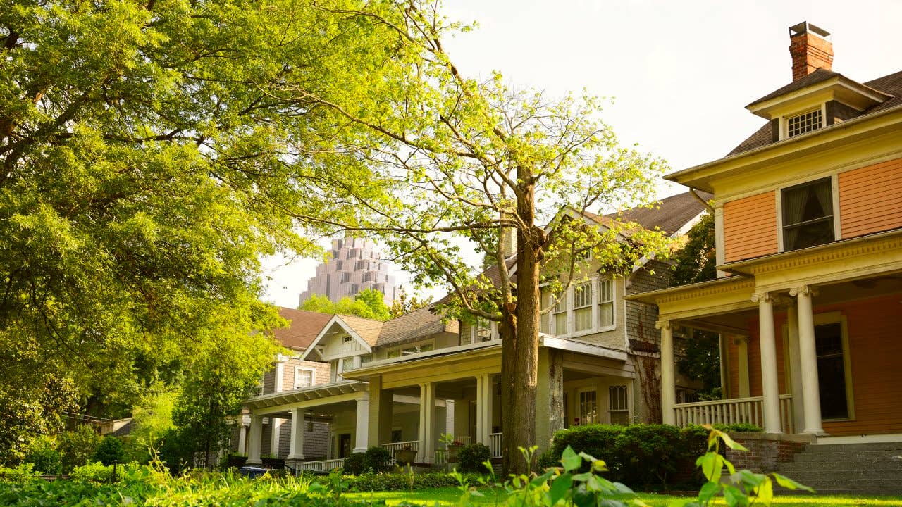 A row of houses surrounded by green grass and trees