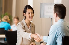 Young Asian professional woman shaking hands