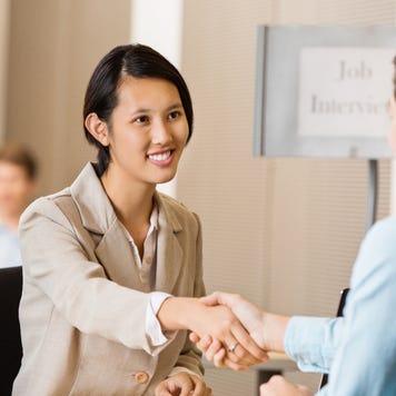 Young Asian professional woman shaking hands
