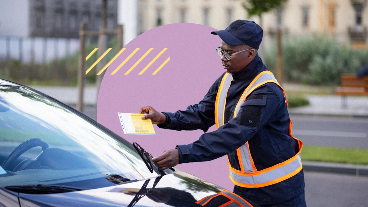 An officer slipping a parking ticket under a car's windshield.