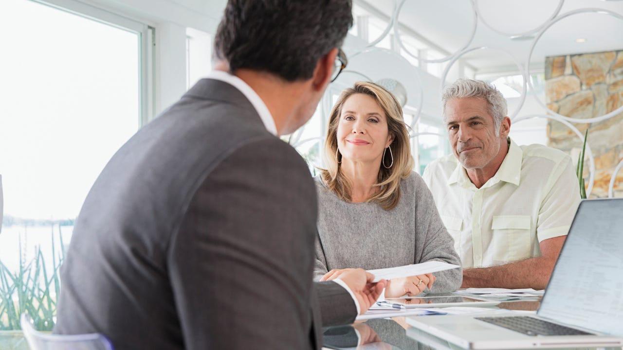 Couple talking to financial advisor