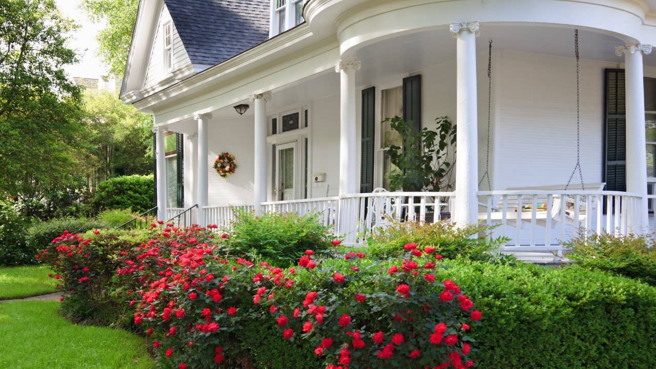 Southern Alabama home with beautiful porch and lovely red roses.