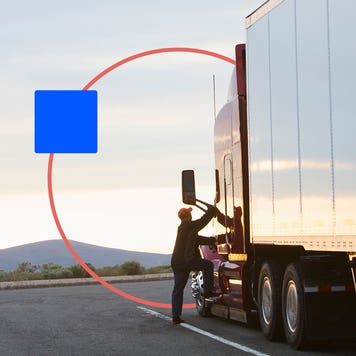 A truck driver steps up into his truck