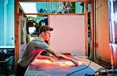 Artist working on a piece in an industrial loft.