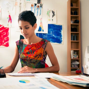 Woman working on a budget and financial documents.
