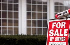 The "For Sale By Owner" sign with available information is seen in front of a home