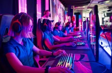 Players competing at video game eSport championship with a coach