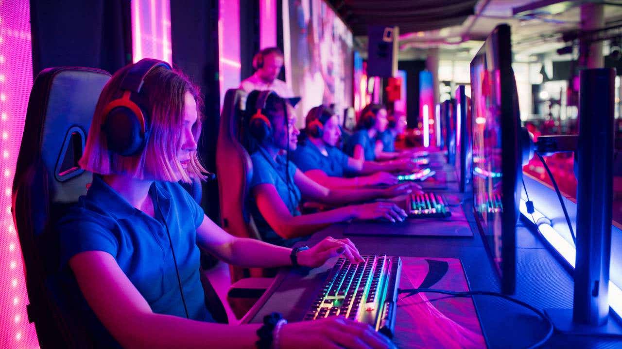 Players competing at video game eSport championship with a coach