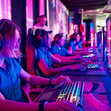 Players competing at video game eSport championship with a coach
