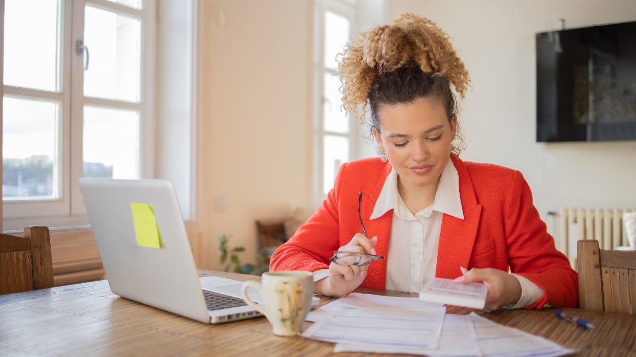 Young woman going through paperwork.