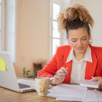 Young woman going through paperwork.