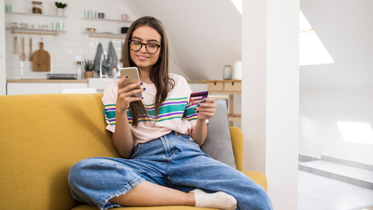 Teenage girl shopping online at home