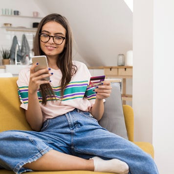 Teenage girl shopping online at home