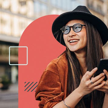 Woman smiling and using a cellphone