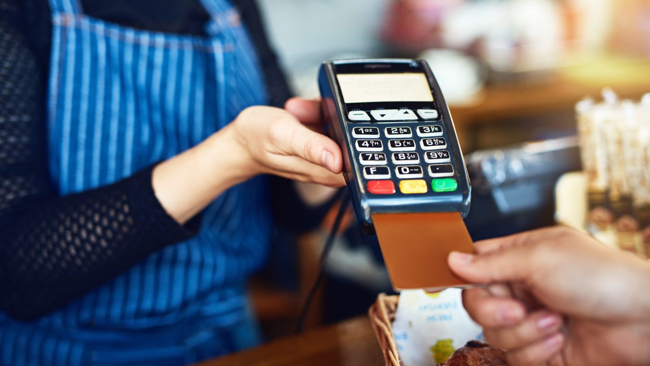 Cropped shot of an unrecognizable man paying for his purchase by card