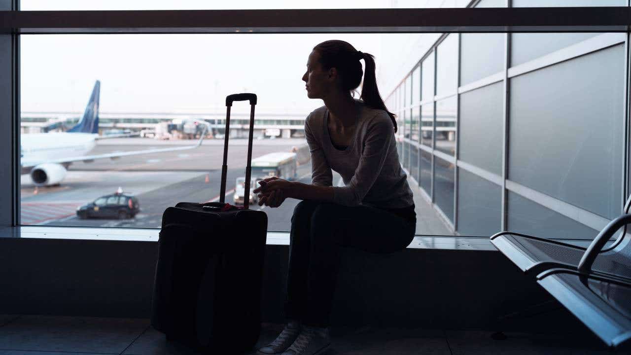 Silhouette of young female passenger at the airport.