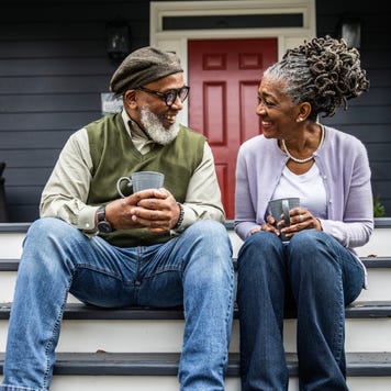 Older coupling drinking coffee on a front porch