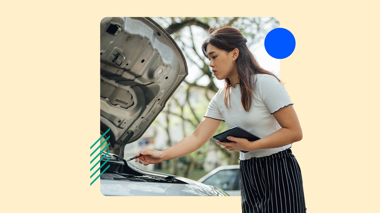 An insurance adjuster inspecting a car with the hood up