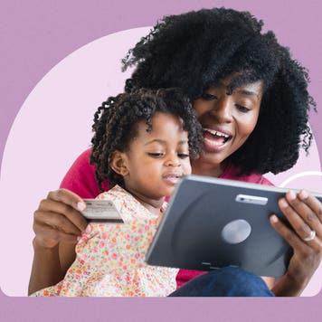 Woman with child holding credit card