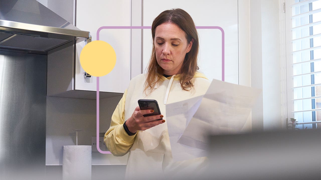 Woman reviewing and paying bills on her cell phone