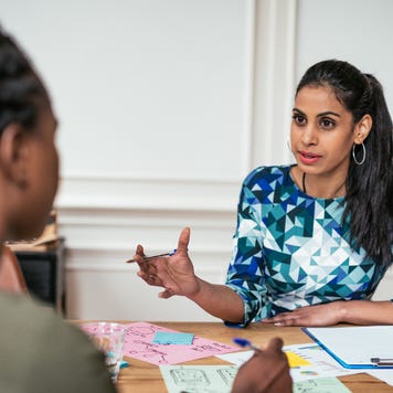 Two women discussing and planning a small business.