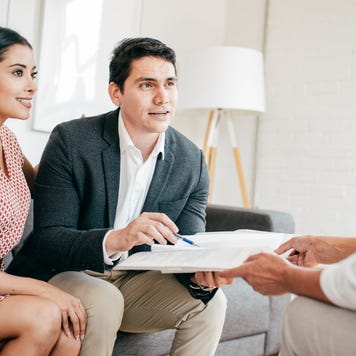 Couple getting financial advice from a female advisor.