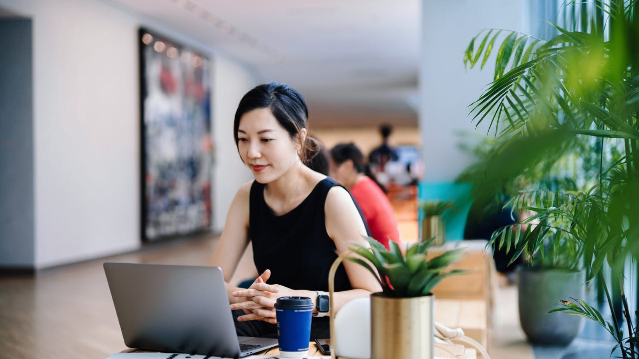 Woman working on a laptop in an office setting