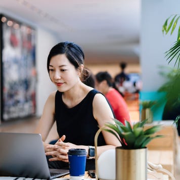 Woman working on a laptop in an office setting
