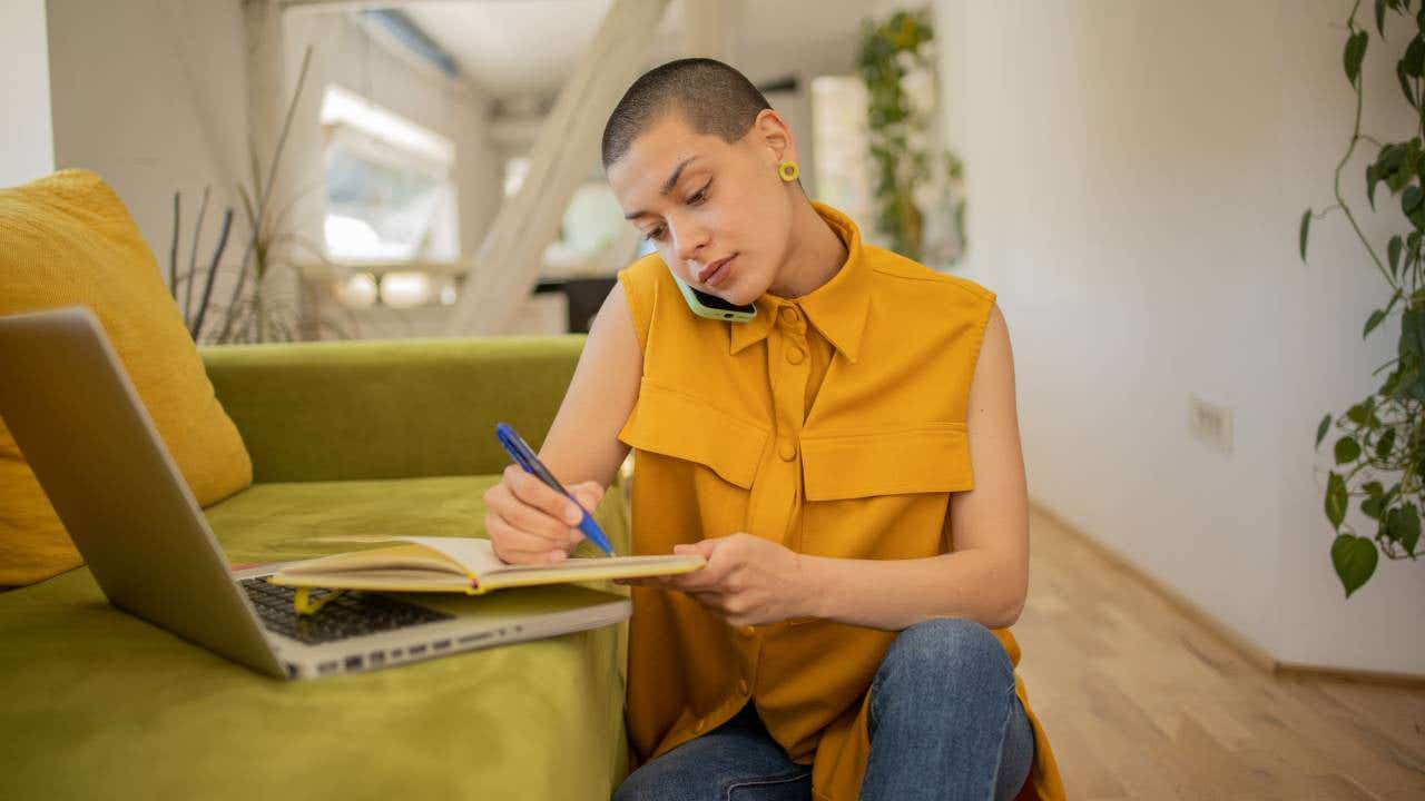 Happy young woman is enjoying working from home