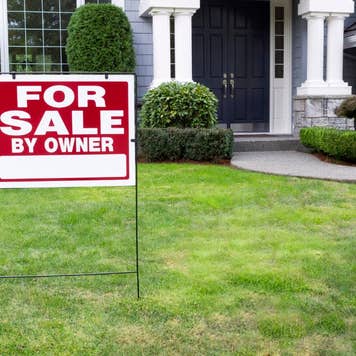 Closeup view of Modern Suburban Home for Sale Real Estate Sign in front of modern home