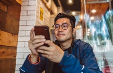 man making order from the digital menu on smartphone in restaurant