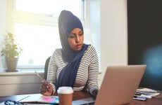 Arabic business owner working on her laptop.