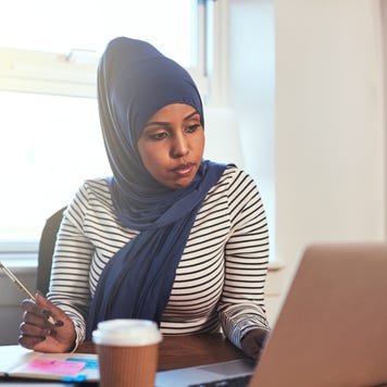 Arabic business owner working on her laptop.