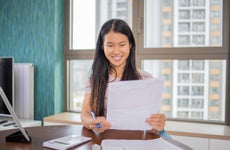 Young woman looking through loan paperwork