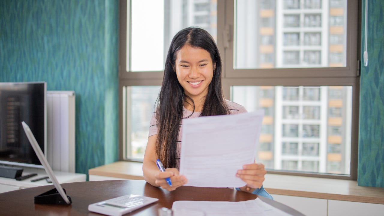 Young woman looking through loan paperwork