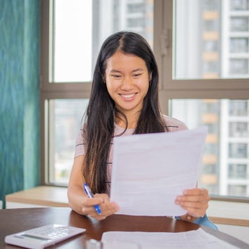 Young woman looking through loan paperwork