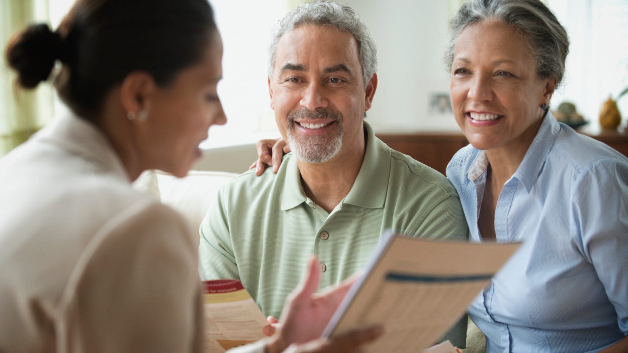 Saleswoman talking to clients in living room